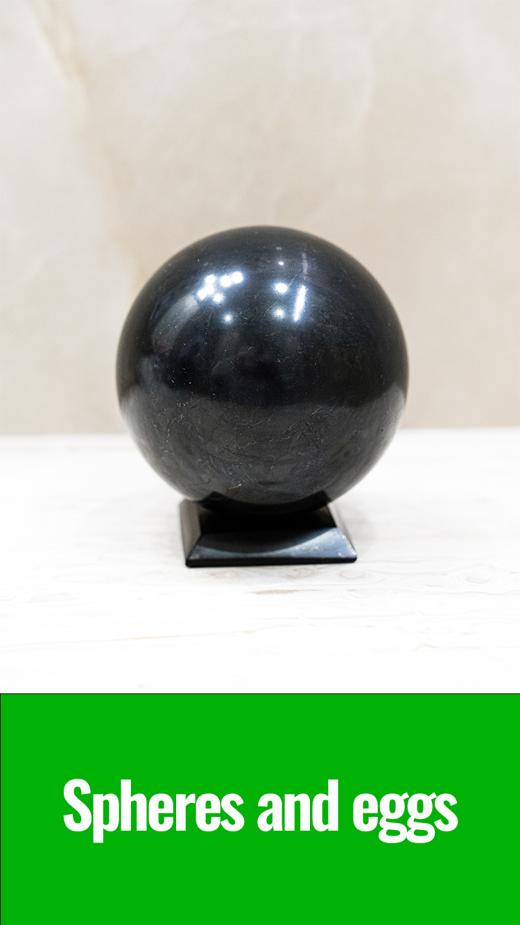 Spheres and eggs - Polished shungite sphere on a stand